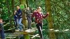 group on high ropes girl in front with father on platform behind watching on